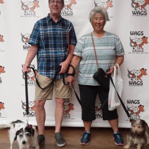 two elderly adopt a dog at WAGS